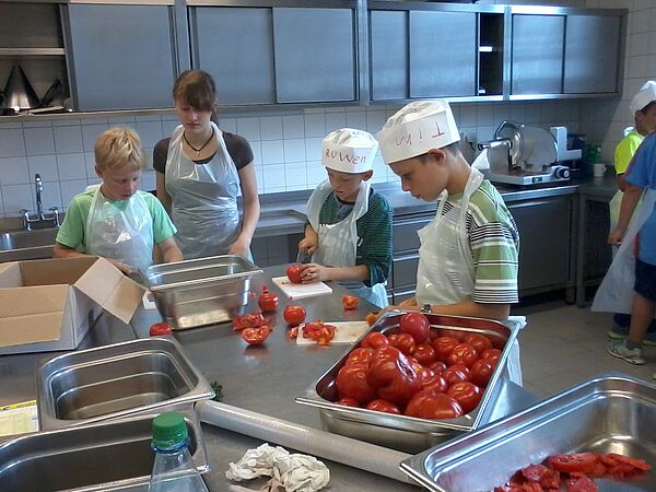 Kinder schneiden Tomaten